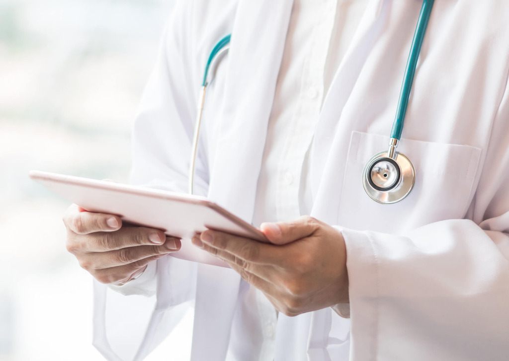 A doctor holding a clipboard